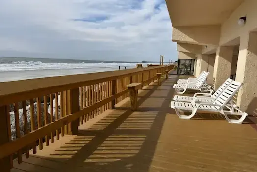 Oceanfront wood deck and railings with lounge chairs at Atalaya Towers in Garden City Beach