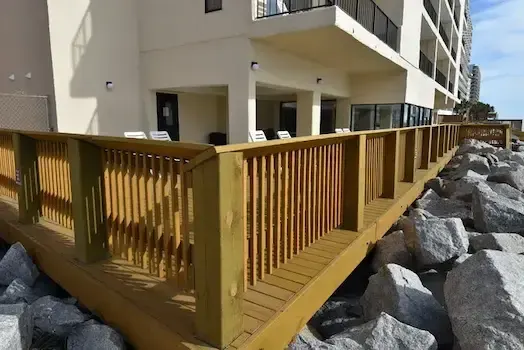 Long view along the new wood deck and railings beside Atalaya Towers