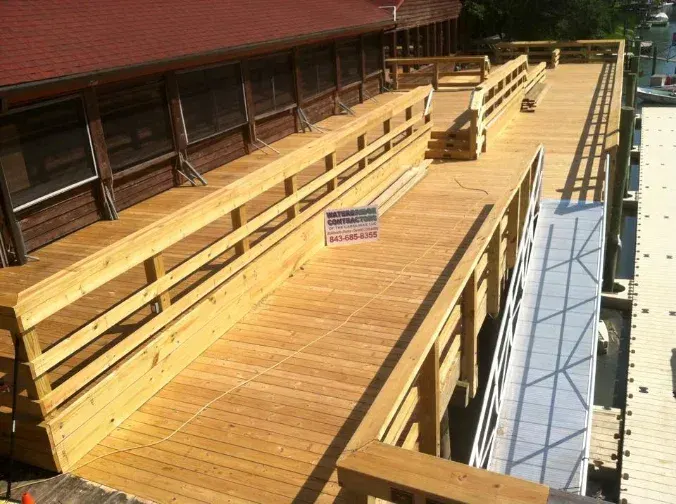 New timber decking, railings and steps beside Bovine’s Restaurant with a Waterbridge project sign