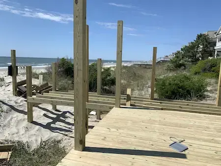 Beach-facing timber deck and walkway framing at Charlestowne Grant with the ocean beyond
