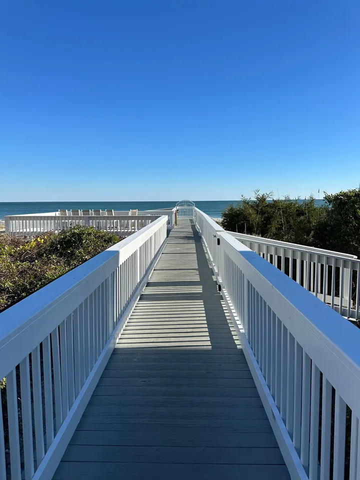 Completed Charlestowne Grant dune walkover with white railings leading toward the ocean