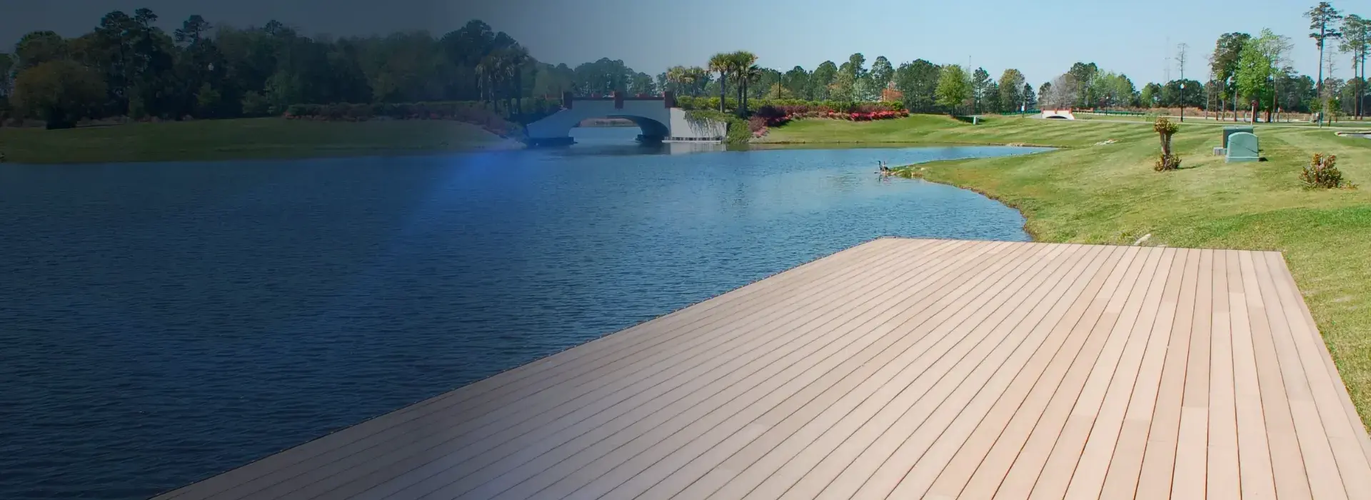 Deck beside a landscaped pond and pedestrian bridges, from Waterbridge’s commercial page