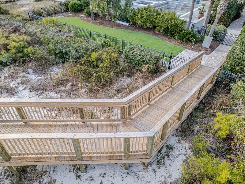 Natural-wood dune crossover landing and property gate in Myrtle Beach