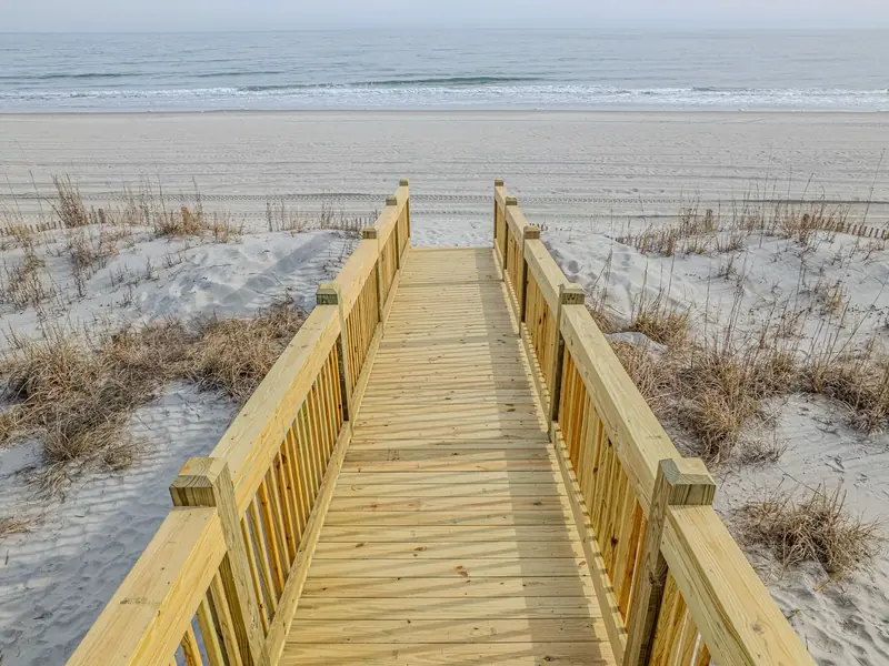 Natural-wood Myrtle Beach dune crossover approaching the Atlantic Ocean
