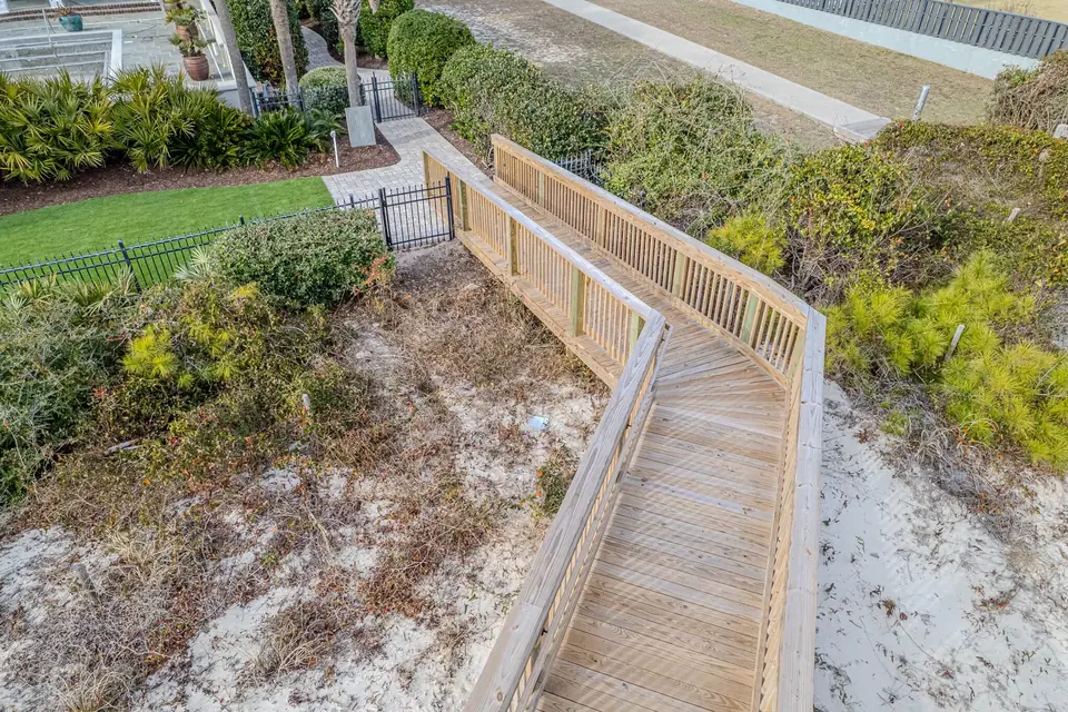 Natural-wood dune crossover landing, railings, and gate connection in Myrtle Beach
