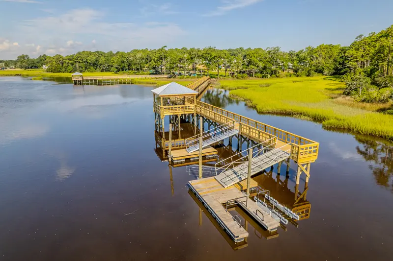 Wide aerial view of the Kingfish Bay pier, covered pierhead, gangways, and floating docks