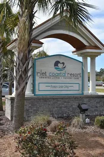 Inlet Coastal Resort assisted living and memory care sign under an arched canopy