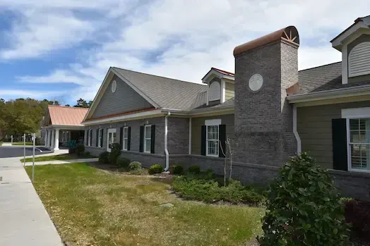 Exterior wall, roofline and landscaped lawn at Inlet Coastal Resort