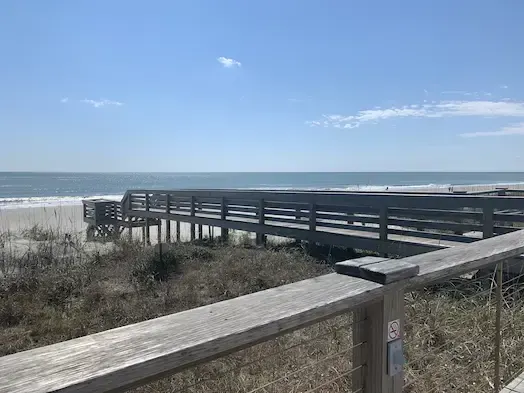 Elevated timber dune crossover at Litchfield by the Sea viewed across dune vegetation