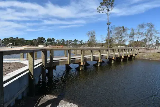 Pier walkway on timber pilings following the edge of the pond at Living Dunes