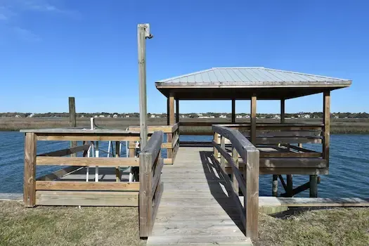 Timber approach to the covered pierhead with floating dock access alongside