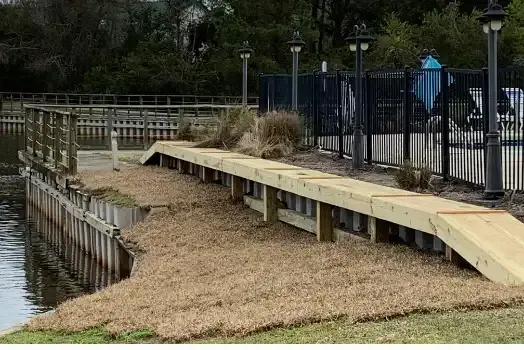 New vinyl bulkhead with a timber cap beside the pool fence at Mingo Town Homes