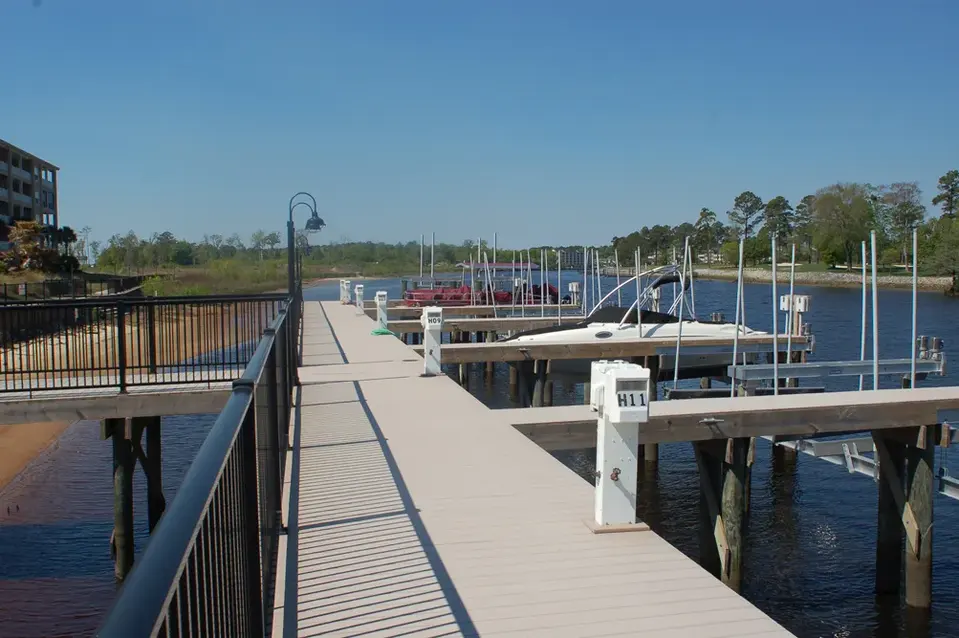 Fixed marina walkway connecting multiple boat slips and floating docks
