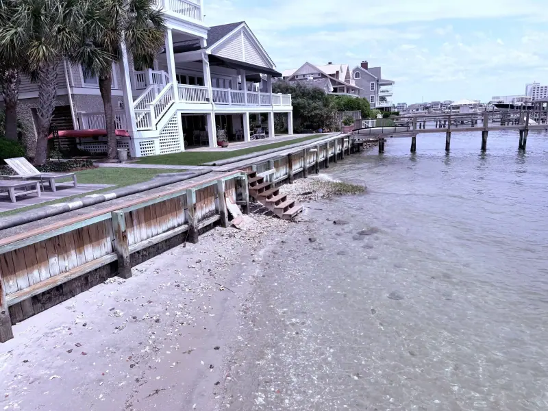 Wide view of the Shore Drive timber seawall at low tide in Wrightsville Beach