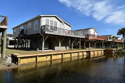 New timber bulkhead and wide timber cap beside the water at an Oceanside Village home in Surfside Beach, SC