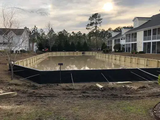 Segmented retaining wall around a residential retention pond