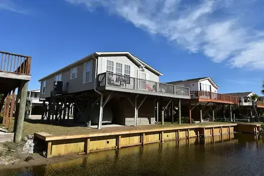 New timber bulkhead along a waterfront home in Oceanside Village