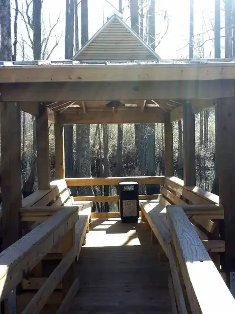 Timber benches inside a covered pier at The Park at Prince Creek in Murrells Inlet