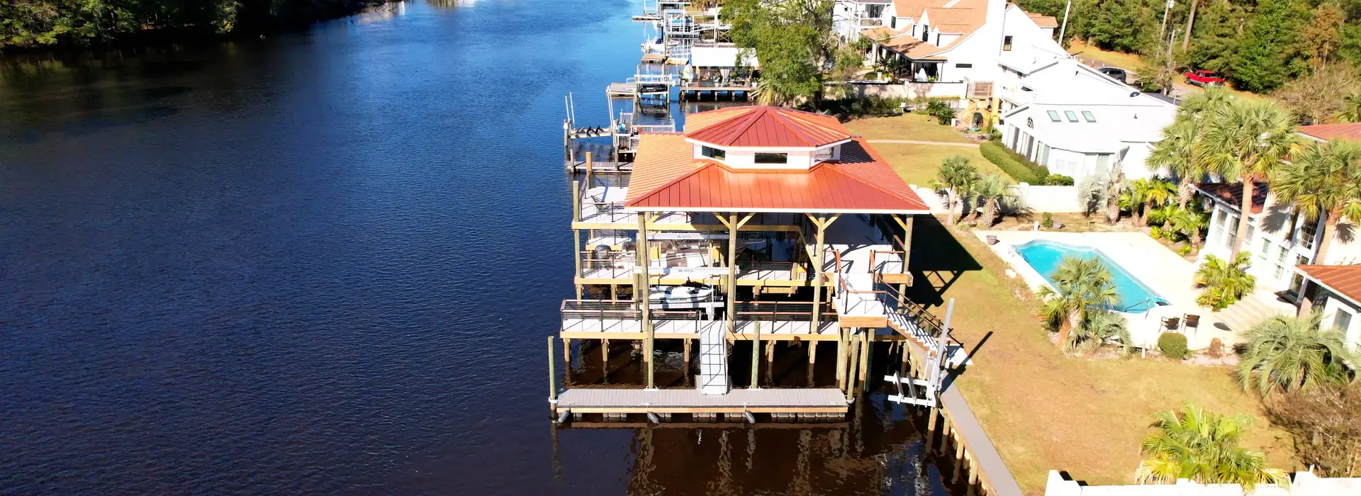 Two-story boathouse, boat lift, fixed dock, and waterfront walkway built by Waterbridge on the Intracoastal Waterway in Myrtle Beach