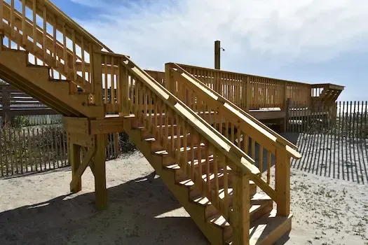Timber stairs and elevated walkway beside the dune at the Surfside Beach project