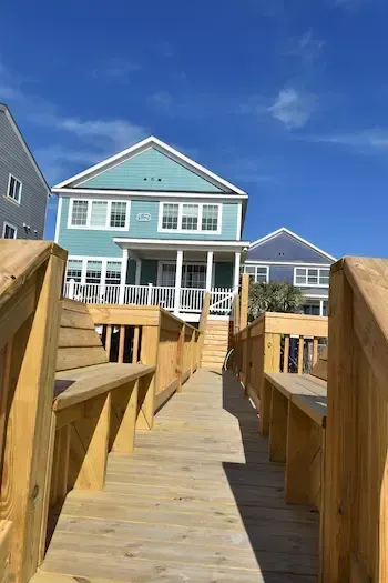 View along the timber walkway toward the Surfside Beach house