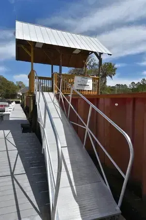 Aluminum gangway leading from the floating dock to a covered pierhead at Wacca Wache Marina